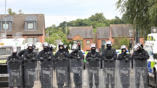 Police officers in riot gear on the Lower Ormeau Road in Belfast on Saturday