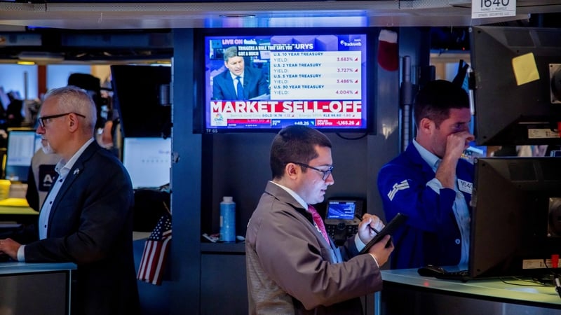A television displays stock market news on the floor of the New York Stock Exchange today