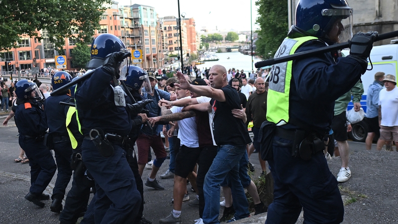 Police officers face off with protesters during an 'Enough is Enough' demonstration