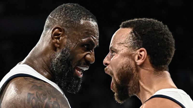 LeBron James (L) celebrates with teammate Steph Curry