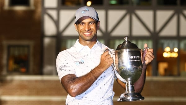 Aaron Rai celebrates with the trophy