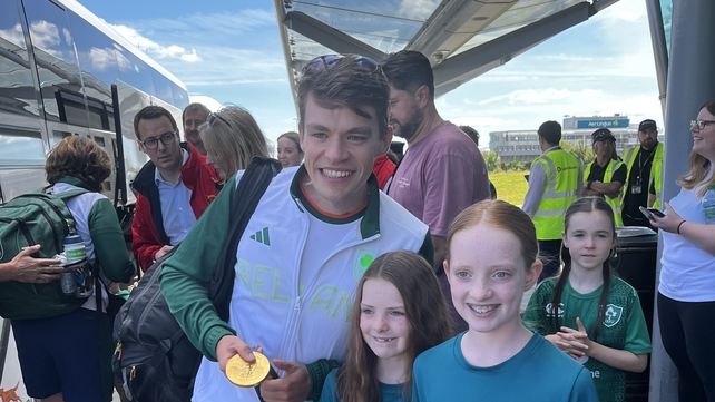 Rower Fintan McCarthy meets some young fans outside Dublin Airport