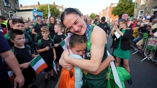 Kellie Harrington hugs 9-year-old Maisie Farrell during her homecoming on Sean McDermott street