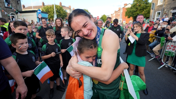 Kellie Harrington hugs 9-year-old Maisie Farrell during her homecoming on Sean McDermott street