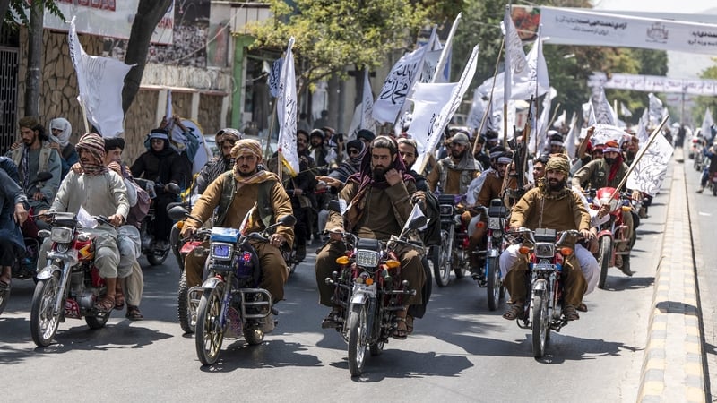 Taliban security personnel ride motorbikes to celebrate the third anniversary of Taliban takeover of Afghanistan