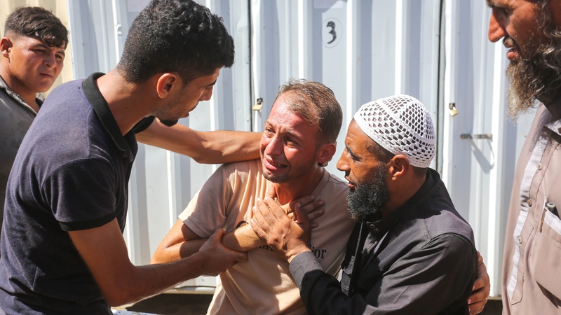 Mohammed Abu Al-Qumsan collects the bodies of his two children, Asser and Ayssel, twins who were just four-days-old
