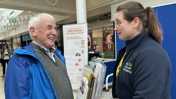 Mike Conneely chatting with a nurse at an Irish Cancer Society roadshow in Galway