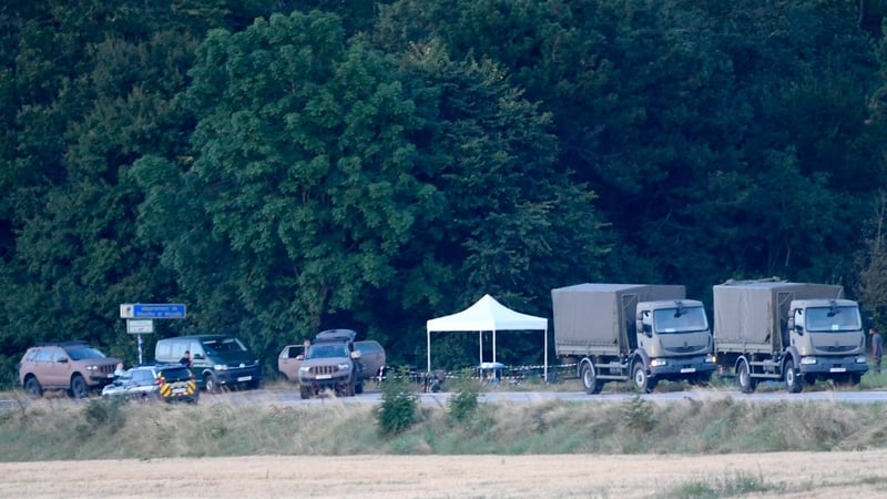 French gendarmes and French military vehicles are pictured near a forest in Autreville following the collision between two Rafale jets