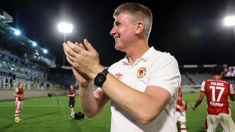Stephen Kenny celebrates with the travelling supporters after the game in Baku