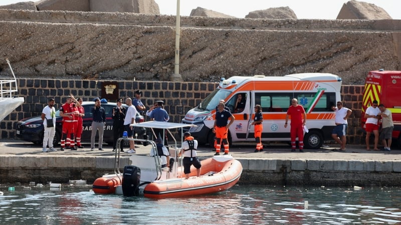Emergency and rescue services work near the scene where a sailboat sank off the coast of Porticello