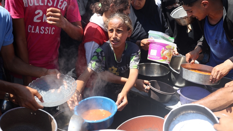 People queue for food at the Bureij refugee camp in central Gaza