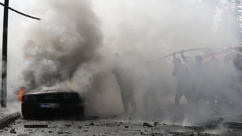 Lebanese firefighters put out a fire in a car in Sidon after an Israeli strike killed a senior Fatah official, according to the Palestinian group