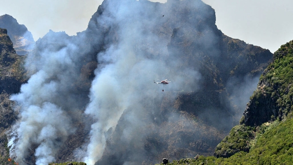 A Regional Civil Protection Service helicopter fights the blaze on Madeira