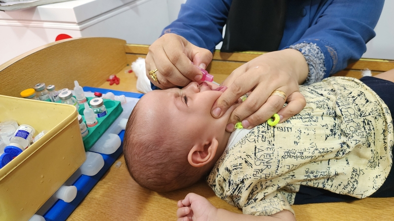 A medical team from the Palestinian Red Crescent administers polio vaccine to a child at Al-Amal Hospital in Khan Younis on 22 August