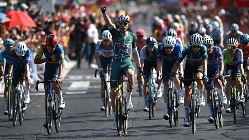 Wout van Aert raises a fist after crossing the line in first position