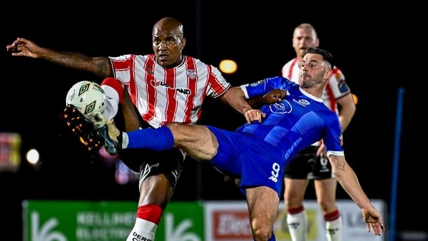 Derry City's Andre Wisdom (L) battles with Padraig Amond of Waterford for possession
