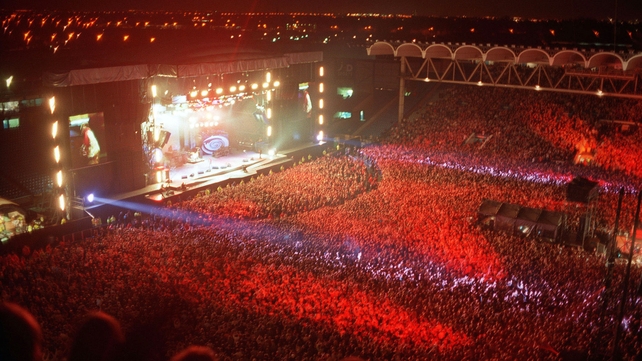 Oasis on stage at Manchester City's football ground, Maine Road, 1996. Photo by Dave Hogan/Getty Images.