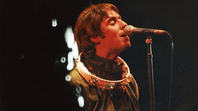 Liam Gallagher performs onstage at Glastonbury in, 1995. Photo by Pete Still/Redferns.