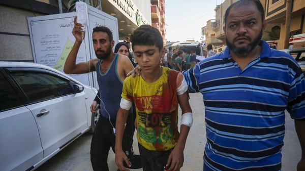 An injured boy is taken to Avde Hospital after Israeli forces shelled the Al-Izz bin Abdul Salam School in the Nuseirat refugee camp