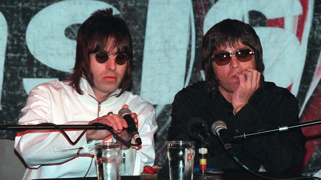 Liam and Noel Gallagher at a press conference in London, 1999, to announce the departure of Oasis founding member Guigsy and Bonehead, who were replaced by Gem Archer and Andy Bell. Photo by Gareth Davies/Getty Images.