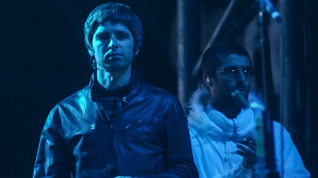 Noel and Liam Gallagher perform at Glastonbury Festival, 2004. Photo by Matt Cardy/Getty Images.