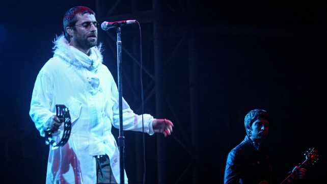 Noel and Liam Gallagher perform at Glastonbury Festival, 2004. Photo by Matt Cardy/Getty Images.