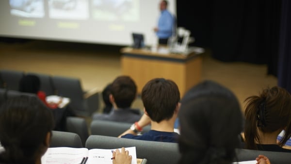 Students sit in a lecture hall listening to a lecture