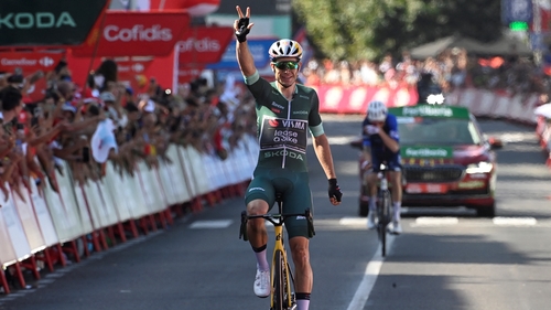 Wout van Aert celebrates at the finish line after winning stage 10