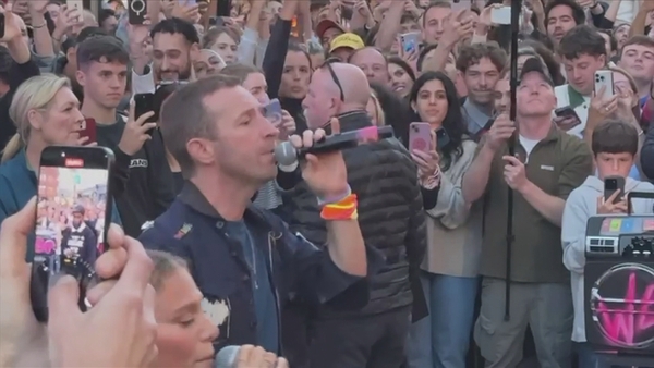 Chris Martin performs Coldplay's new track We Pray on Grafton Street