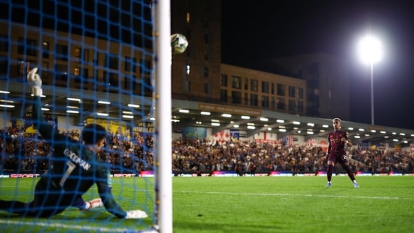 Omari Hutchinson of Ipswich Town has a penalty saved by Wimbledon goalkeeper Owen Goodman