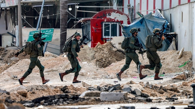 Israeli soldiers take position during an army operation in Tulkarm in the north of the occupied West Bank