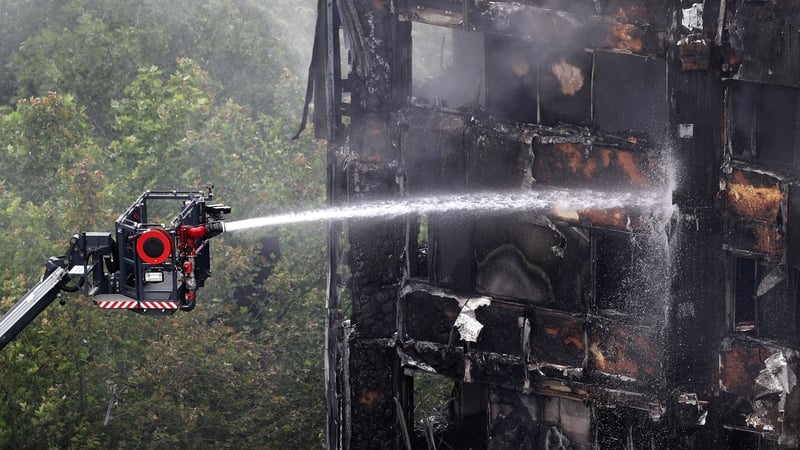 The smouldering remains of cladding on the burnt-out shell of the Grenfell Tower, after the conflagration engulfed the building, claiming 72 lives
