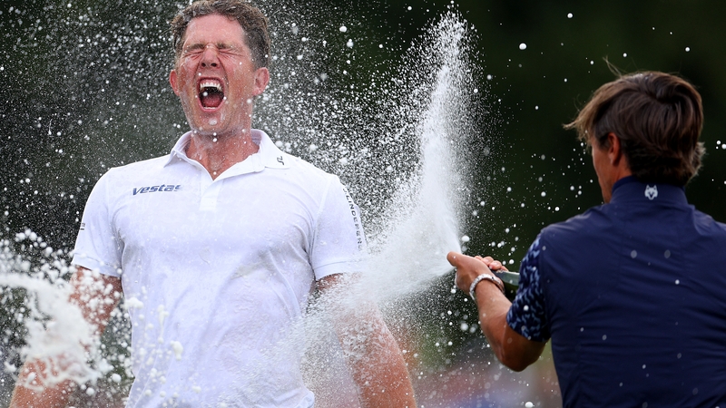 Niklas Norgaard is sprayed with champagne by fellow Dane, Thorbjorn Olesen