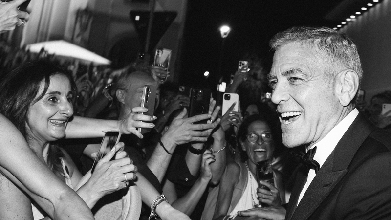 George Clooney interacts with fans during the Wolfs red carpet during the 81st Venice International Film Festival on Monday in Venice, Italy. (Photo by Pascal Le Segretain/Getty Images)