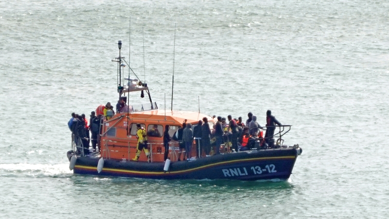 A group of people - thought to be some of those rescued after a boat sank off the French coast - are brought to Dover, Kent, onboard the RNLI Dungeness lifeboat