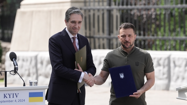 Simon Harris and Volodymyr Zelensky shake hands after signing the joint memorandum