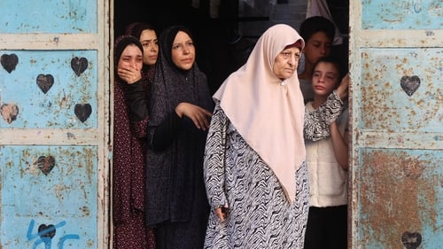 Women mourn during the funeral of a family member killed during an Israeli strike