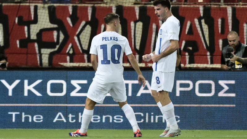 Greece's two-goal hero Fotis Ioannidis (R) celebrates with Dimitris Pelkas