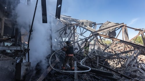 Ukrainian emergency service workers extinguish a fire in a factory after Russian shelling destroyed a building in Kostiantinivka, Ukraine