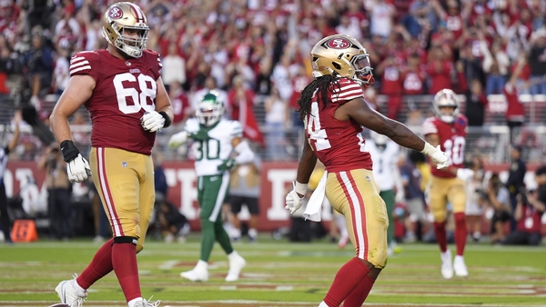 Jordan Mason (r) of the 49ers celebrates a touchdown