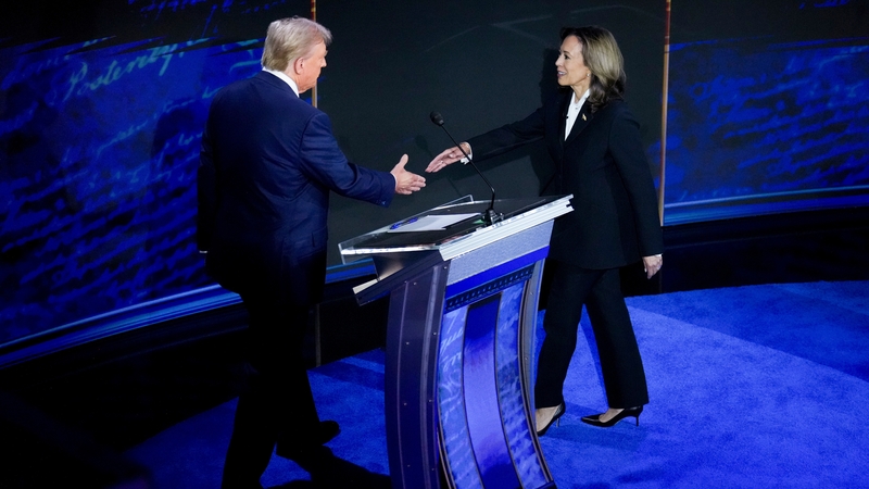Kamala Harris crossed the stage to where Donald Trump was standing, her arm stretched out almost demanding the handshake