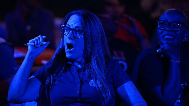 People react as they gather to watch the presidential debate between Donald Trump and Kamala Harris
