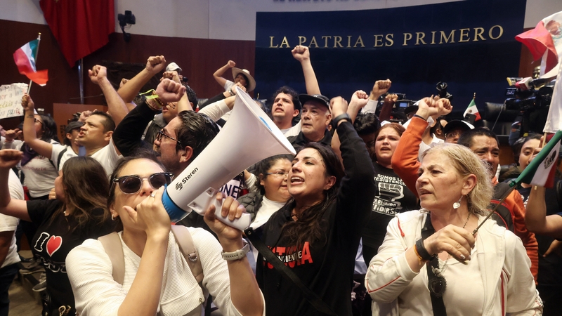 The reform was approved after politicians were forced to move to a new venue due to protests