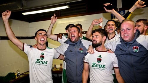 Cork City manager Tim Clancy, centre, and players celebrate after their promotion-sealing win over UCD last week
