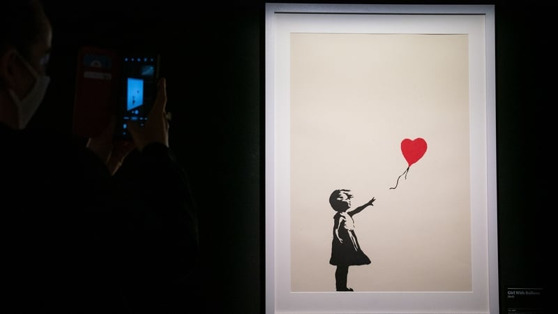 'Girl with Balloon' is seen during The Art of Banksy exhibition in London in 2019