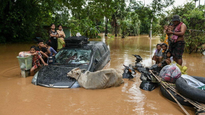 Flood-affected residents wait for a rescue boat to arrive in Taungoo, Myanmar's Bago region