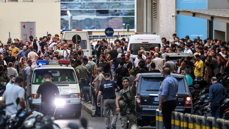 Ambulances are surrounded by people at the American University of Beirut Medical Center