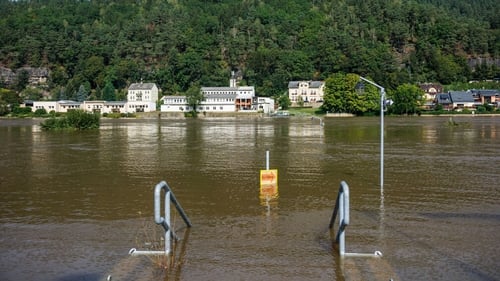 A road sign almost submerged in floodwater in Krippen, eastern Germany