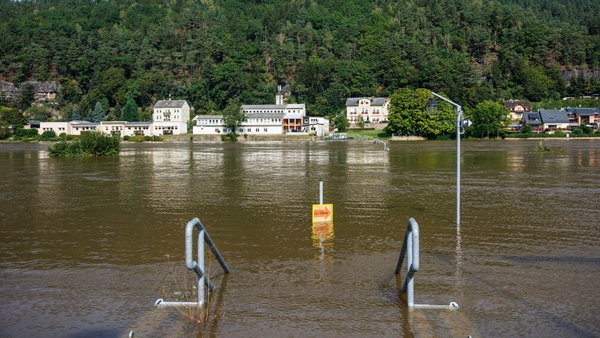 A road sign almost submerged in floodwater in Krippen, eastern Germany