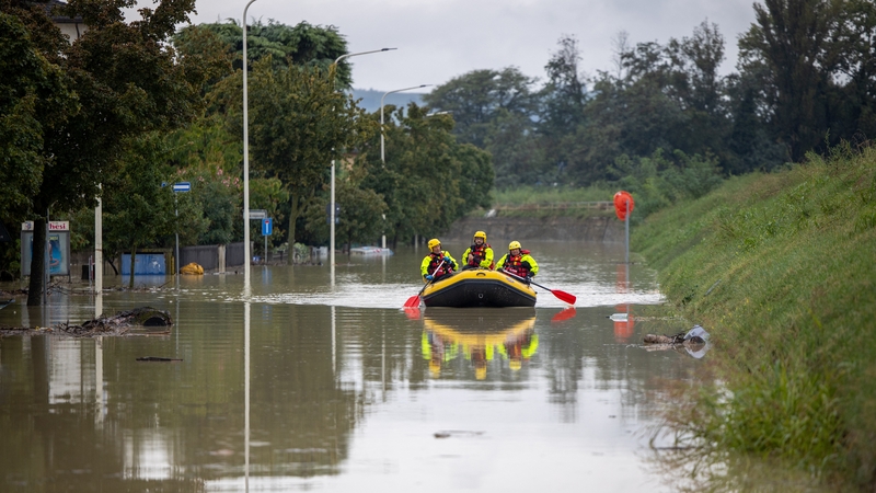 Civil defence members use a dinghy boat to bring medicines to inhabitants stuck in their flooded homes in Faenza, northern Italy